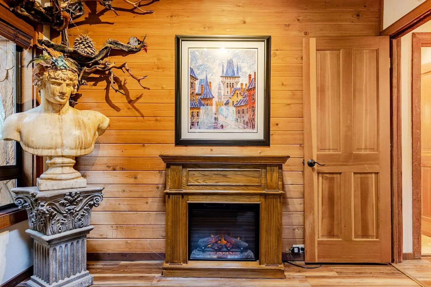Sculptural art details beside the stone fireplace at Faerie House Idyllwild, a design-forward cabin rental