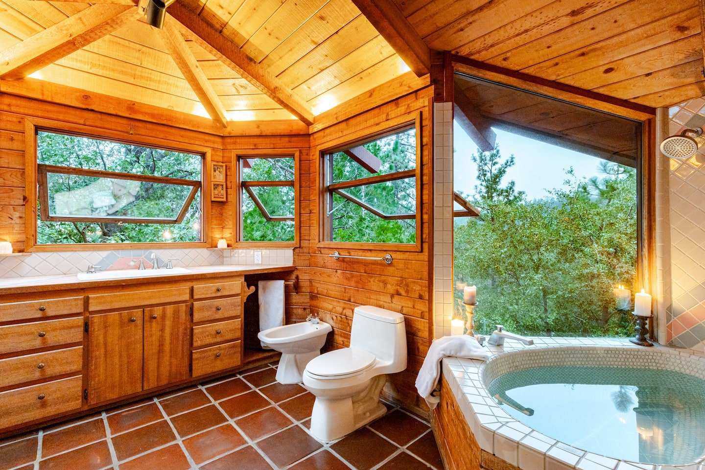 Sunset light filling the forest-view bathroom at Faerie House Idyllwild