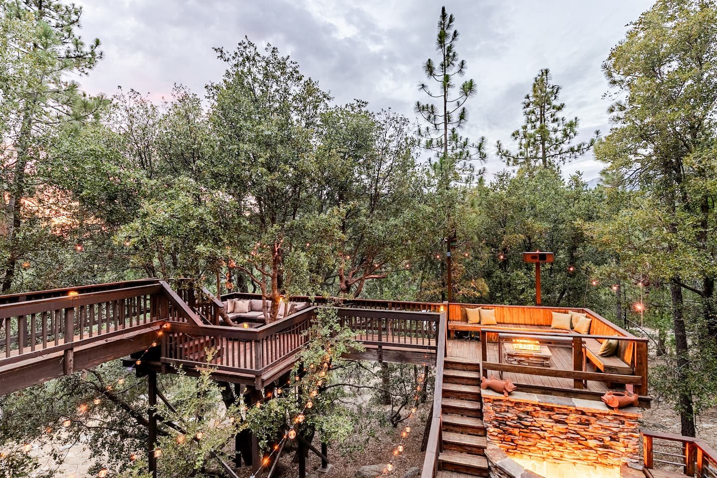 Multi-level decks stepping through the forest at Faerie House Idyllwild retreat