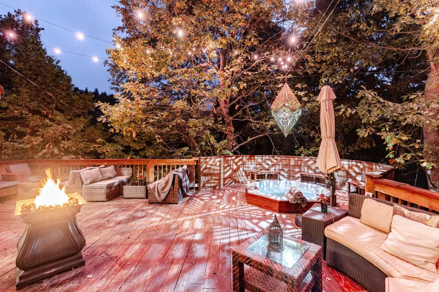 Expansive forest deck with fire pit seating for group retreats at Faerie House Idyllwild
