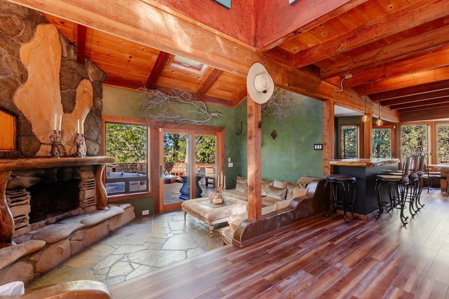 Cathedral atrium great room with soaring wood ceilings and walls of glass at Faerie House Idyllwild vacation rental