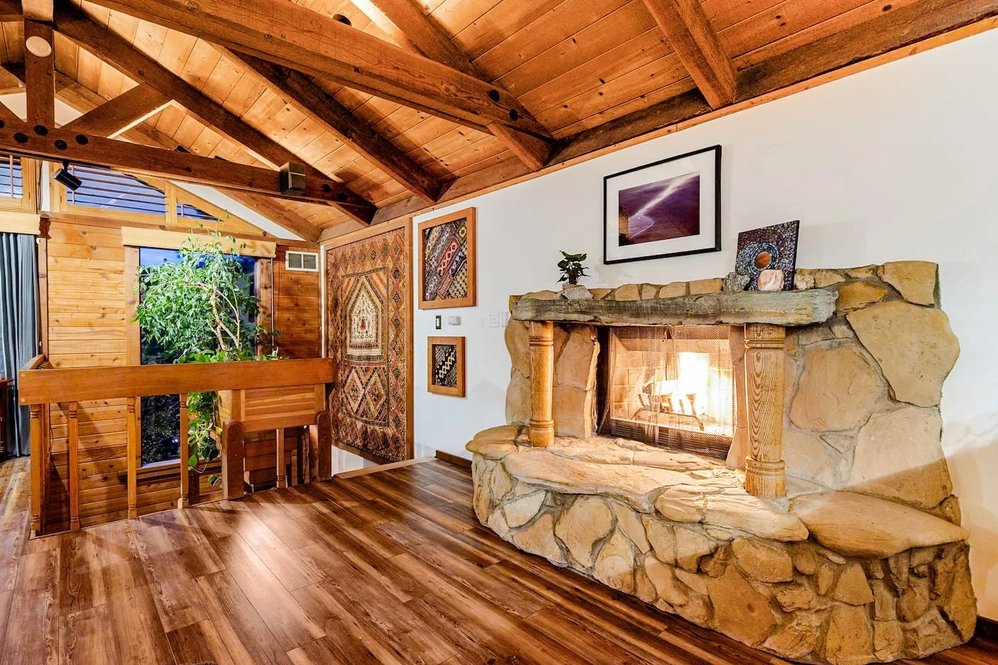 Treehouse loft bedroom with romantic fireplace at Faerie House Idyllwild cabin
