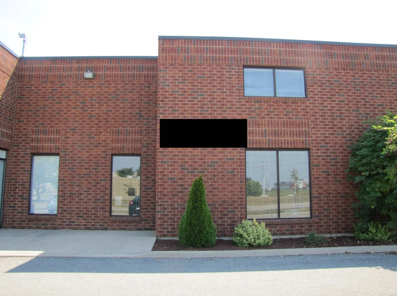 Industrial building for lease in St. Catharines - 330 Vansickle Road #2 which features small front showroom and an open warehouse with grade level door access at the back.