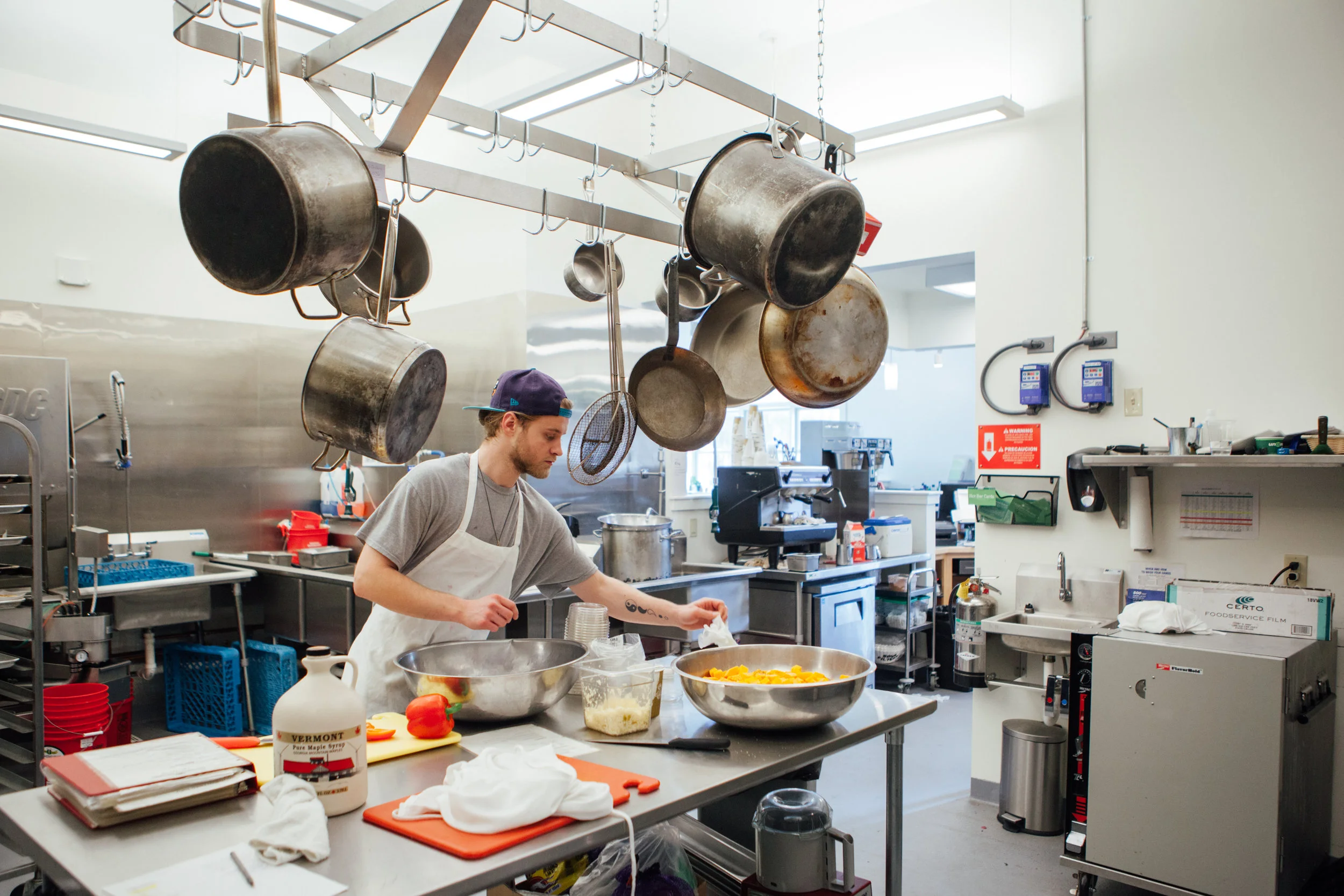 Our talented cook Jason prepares a salad in our much bigger and better new kitchen space!