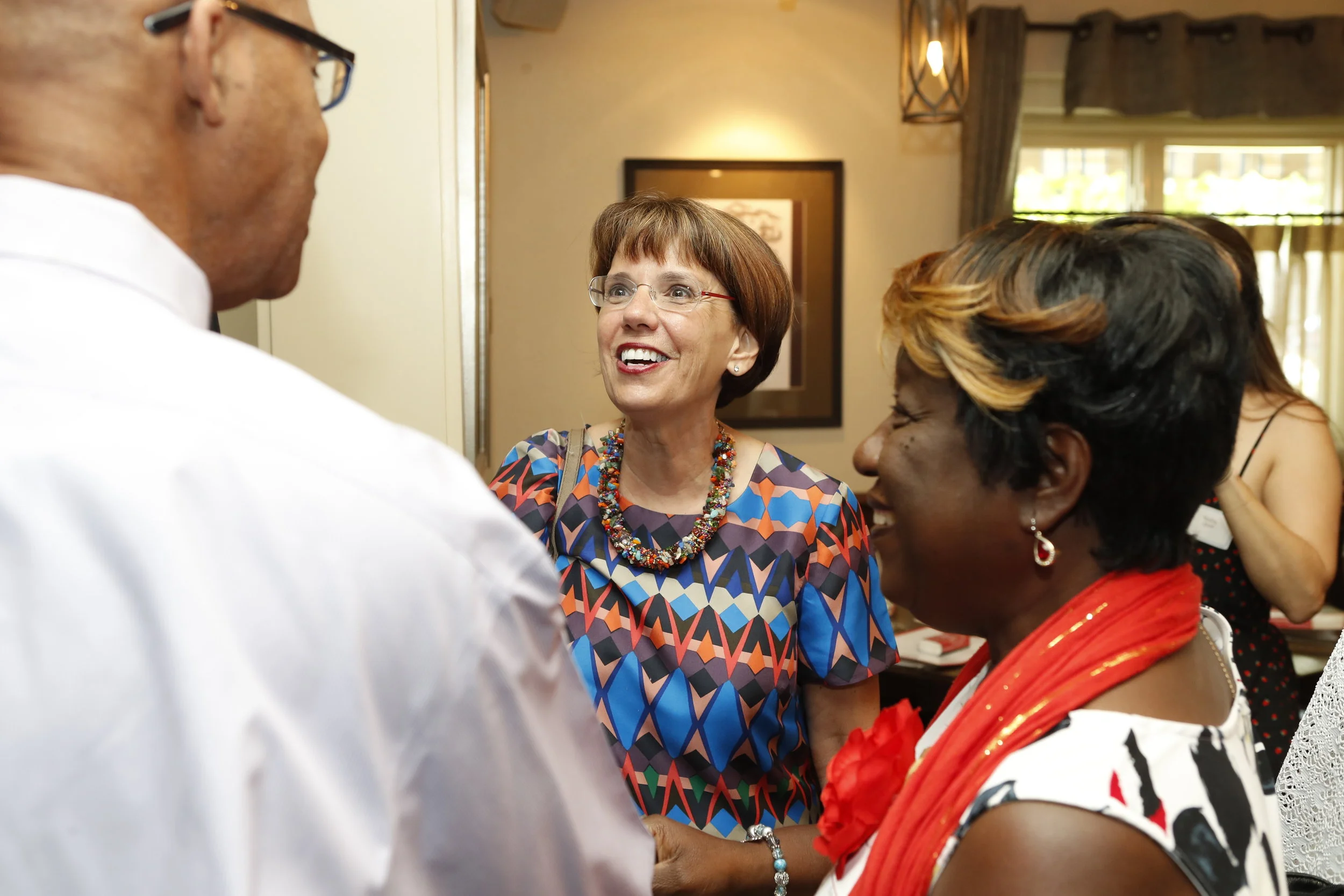 Sandra Owens Cook (right) with her husband, Darryl Cook (left), talking with Jeanne Geoffray (center) at the AEC 2018 Reunion