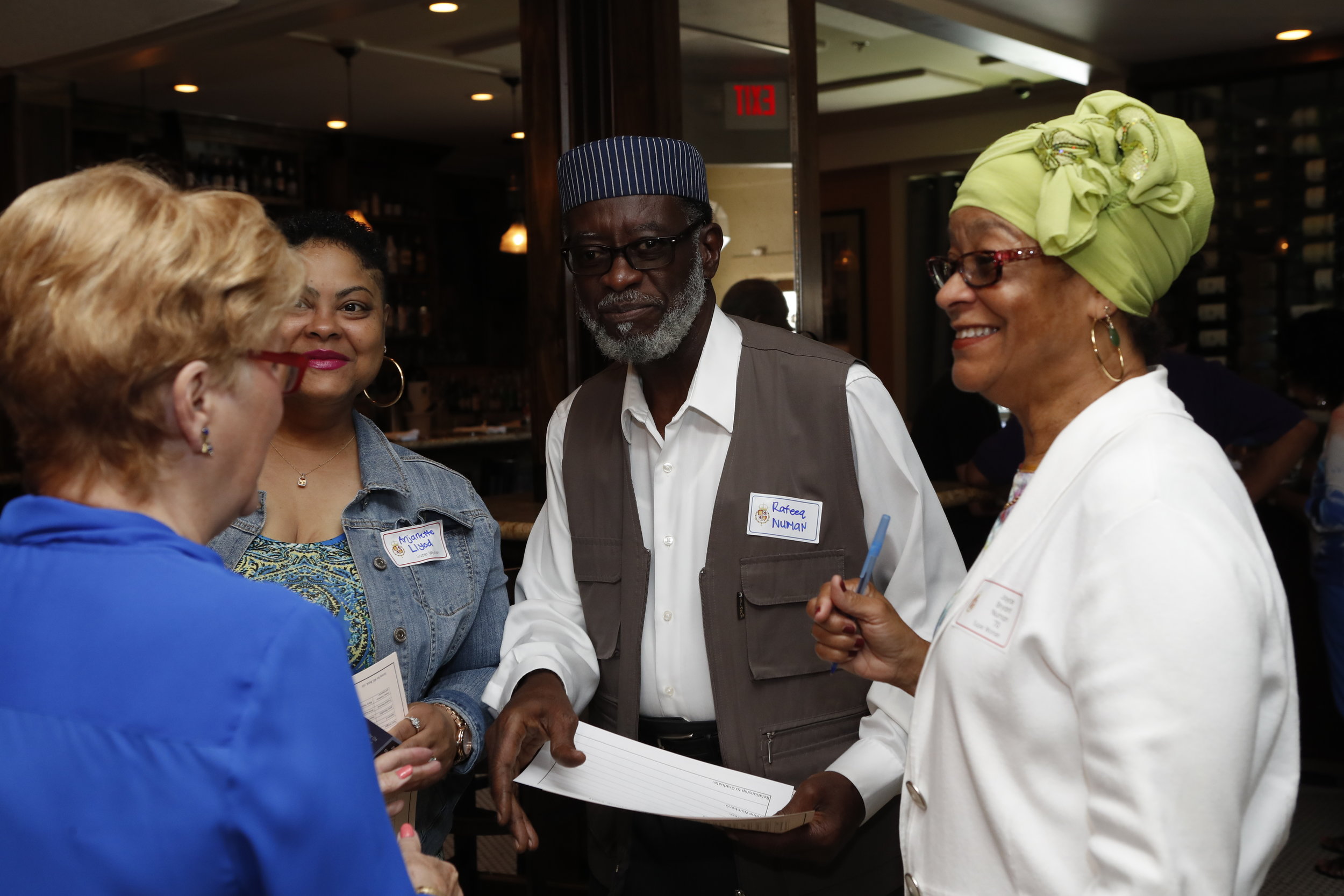 Joyce Nu’Man (right), with her daughter and husband, catch up with Sharon Rodi at the AEC 2018 Reunion