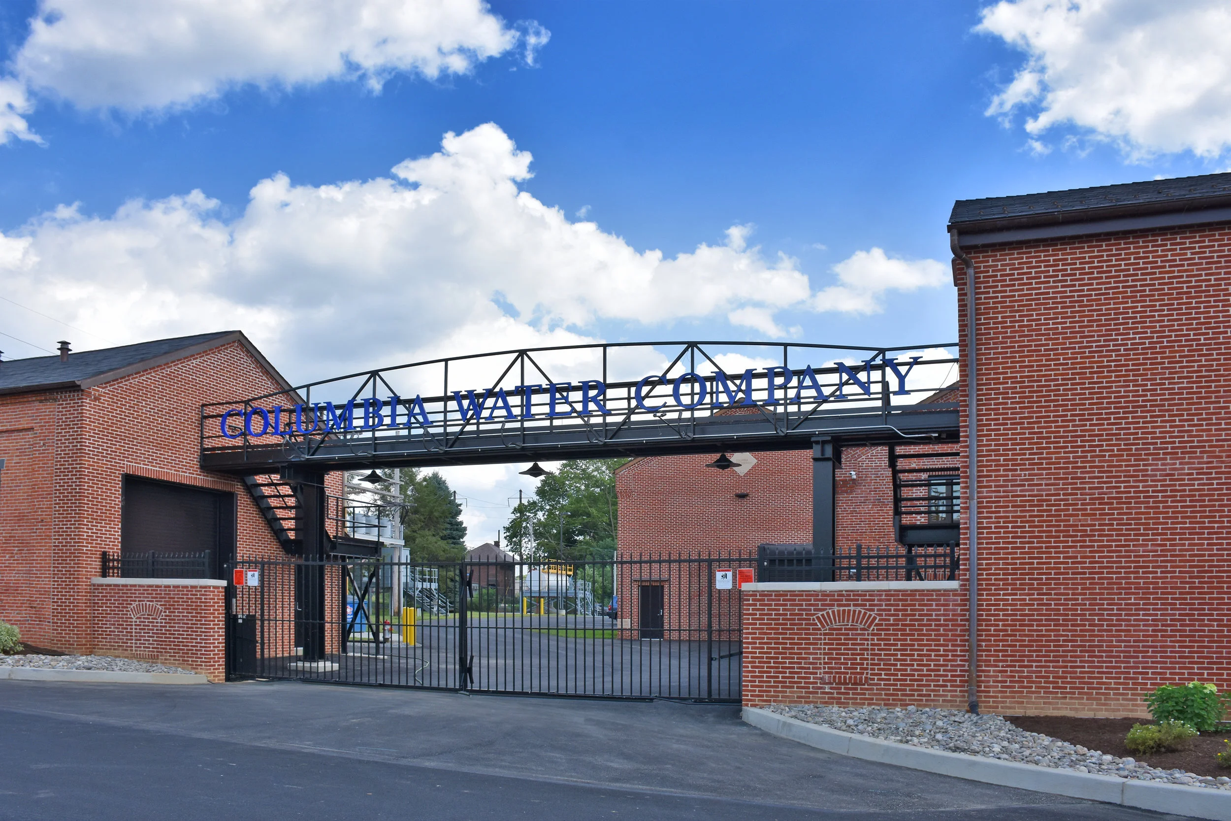 Columbia Water Company | Plant Renovations Founded in the mid-1800s, the Columbia Water Company (CWC) operates a historic water treatment facility along the Susquehanna River. The plant features several structures on the state’s Historic Register dating back to 1849 and is located in the flood plain. While mitigating strategies have been implemented to locate critical equipment out of the flood plain and a floodwall has been constructed, CWC recognizes the unique historic significance and landlocked nature of the plant which necessitated innovative approaches to meet increasing demands. Buchart Horn Architects provided architectural design services for the renovations and additions to Columbia Water Treatment Plant in Columbia, PA. The historic facility was originally constructed in 1849 and resides on the eastern shore of the Susquehanna River. Renovations to several of the original structures on site, in addition to several new buildings, were presented to the Historic Architectural Review Board for approval prior to construction. Existing support structures were modified to support the water treatment process by lifting all essential equipment out of the floodplain. Traditional brick detailing, copper gutters, and wrought-iron fences were used to balance new construction with existing conditions. New site work included security fencing and a concrete ice wall with a brick finish to protect vital equipment from floating ice.