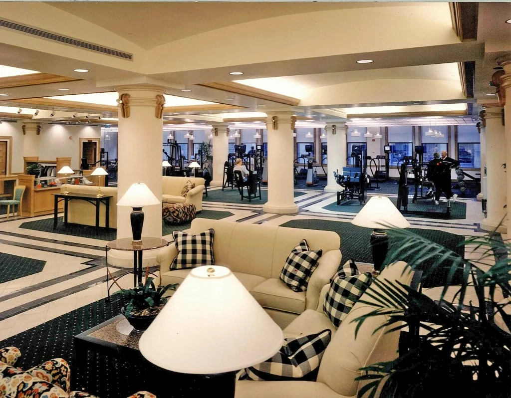 The Duquesne Club Health and Fitness Center, inside the fourth floor of the former Gimbel building on Sixth Avenue, was conceived to provide the Club with world class exercise facilities for an enlarging membership. This space was chosen because of its expansive floor area and its adjacency to the existing Club. The project was an ambitious undertaking for a conservative institution that wanted to respond to the needs of a changing membership. This was the first time that the 110 year old Club had ventured outside of its protective walls. Immediately inside the 21,000 SF Center’s front door is a large living room, the “meet and greet’ space and spectator area for the Fitness Center. Beyond the living room, consideration was given to the need to add scale and spatial effects, and the need to give the existing structure a new, enriched and interesting character. French limestone, in beige and black, American Beech, green marble and several granites were the materials chosen to support the classical character of the facility.