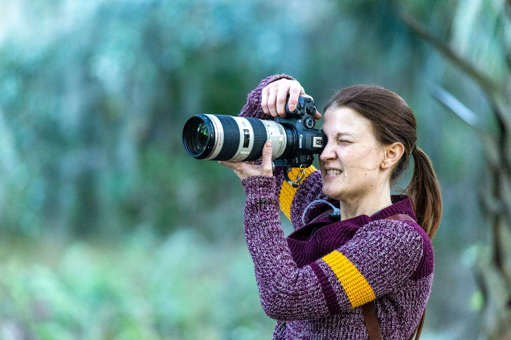 Lady Walker, professional proposal photographer in New Orleans, takes a photo on a Canon R6 MKII in New Orleans City Park.