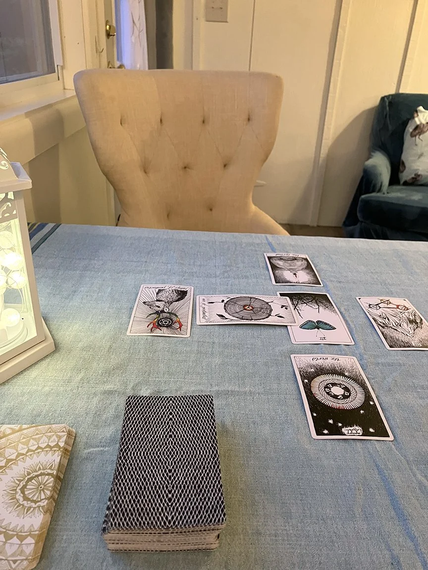 Table with empty chair and tarot cards