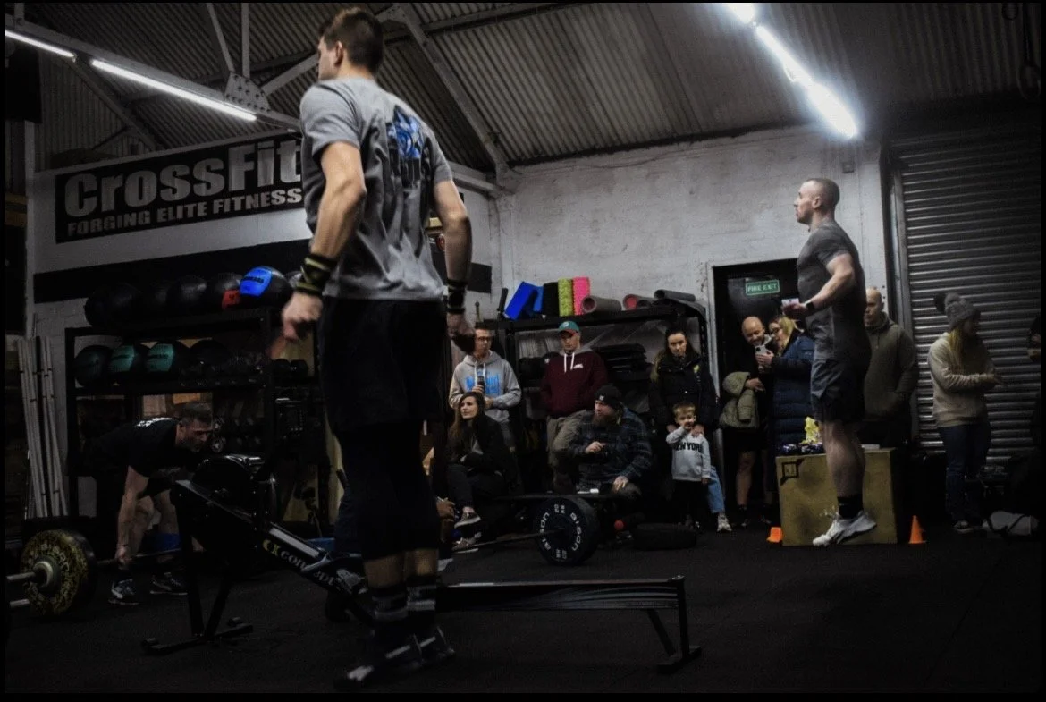 Image of CrossFit workout skipping workout with gym members and family in the background supporting the workout - part of CrossFit Open 2025