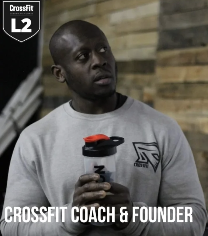 Founder Is in gray sweatshirt holding a water bottle with a red lid, standing in front of a wooden wall. The image includes a logo for CrossFit with the words "CrossFit Coach & Founder" at the bottom.