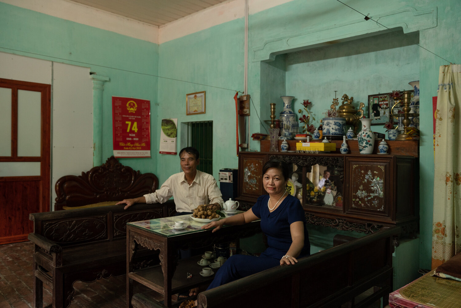  July 15, 2019 - Hung Yen, Vietnam. TRINH THI MINH Tuyet (49) in her home. The family grow Longans, she is chair woman of the Woman's Union. She receives her VSS subcription free from the government. © Nicolas Axelrod / Ruom 