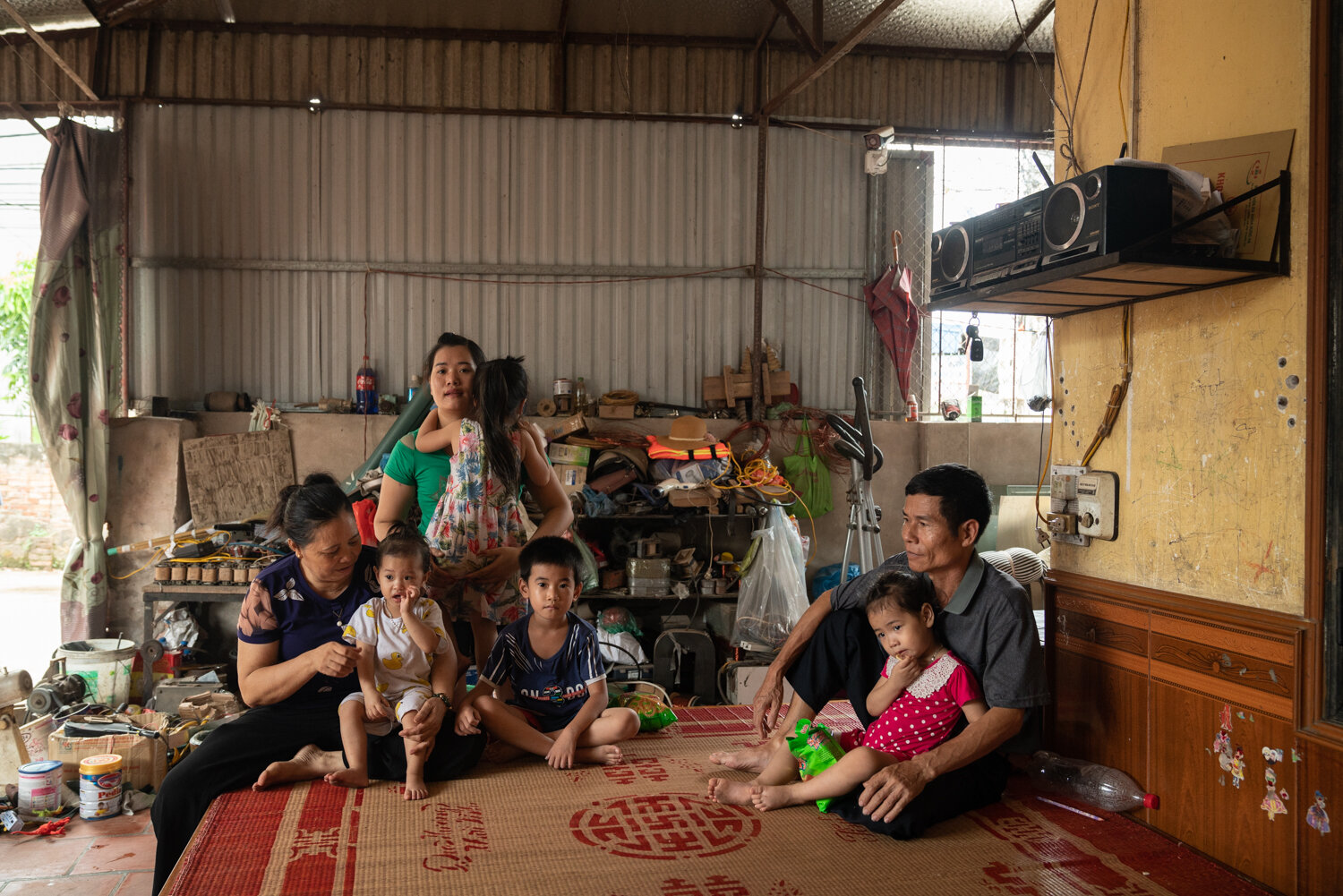  July 16, 2019 - Hung Yen, Vietnam. NGUYEN THI Quyen (55) with her family in their home. Quyen is diabetic, and she participates to her VSS health insurance independently.  © Nicolas Axelrod / Ruom 