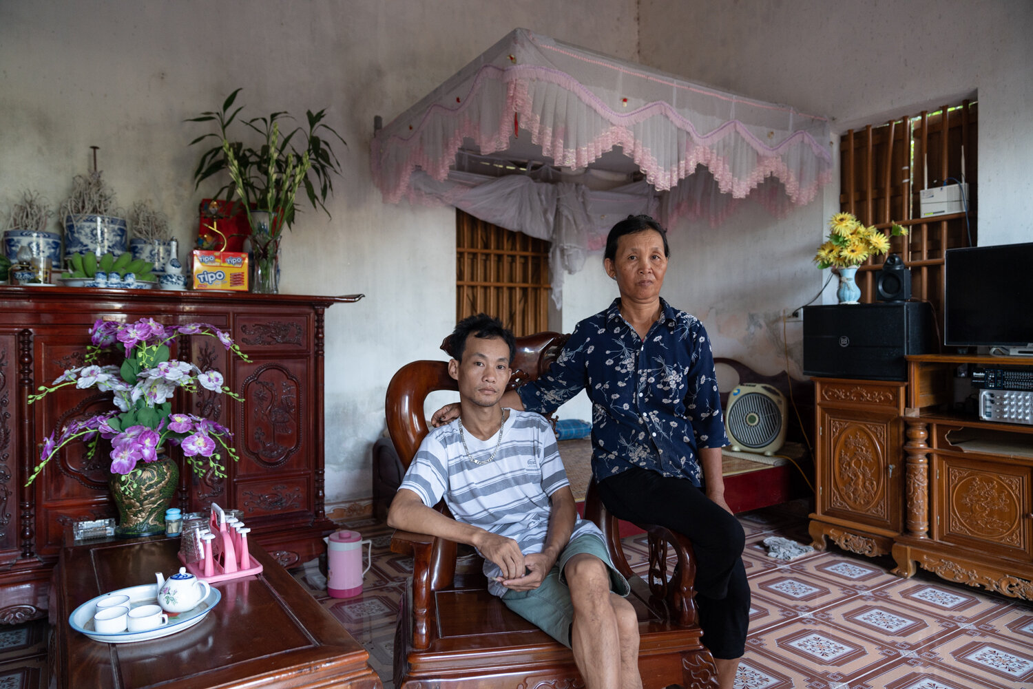  July 16, 2019 - Hung Yen, Vietnam. VUONG QUOC Nhat (30) and his mother THI LIEN Mon Le (56). Nhat was diagnosed with kidney failure. The family started to contribute to VSS health insurance after he got sick. He is waiting on a kidney transplant. © 
