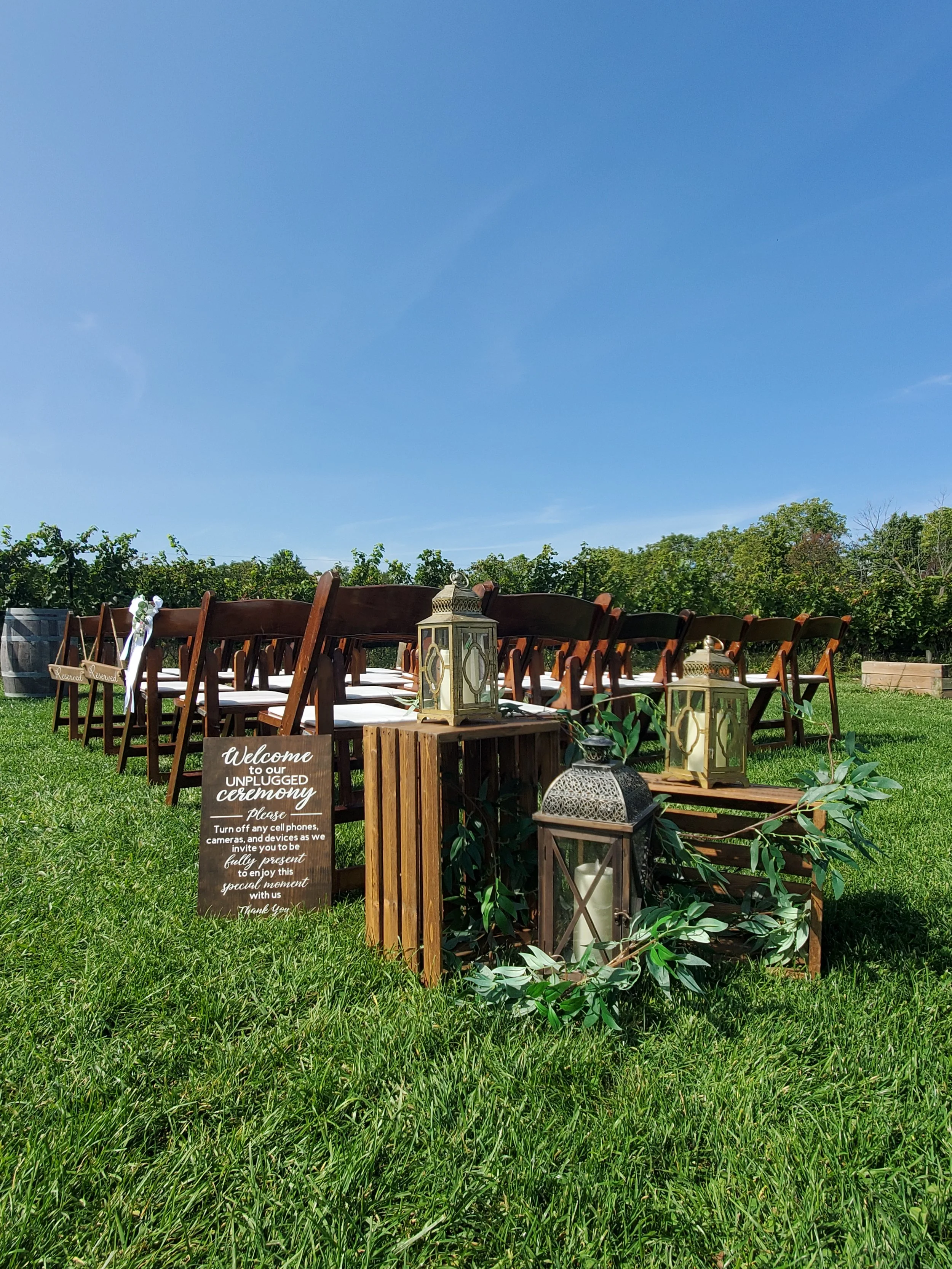Crate & Lantern arrangement at the beginning of the aisle for this outdoor ceremony