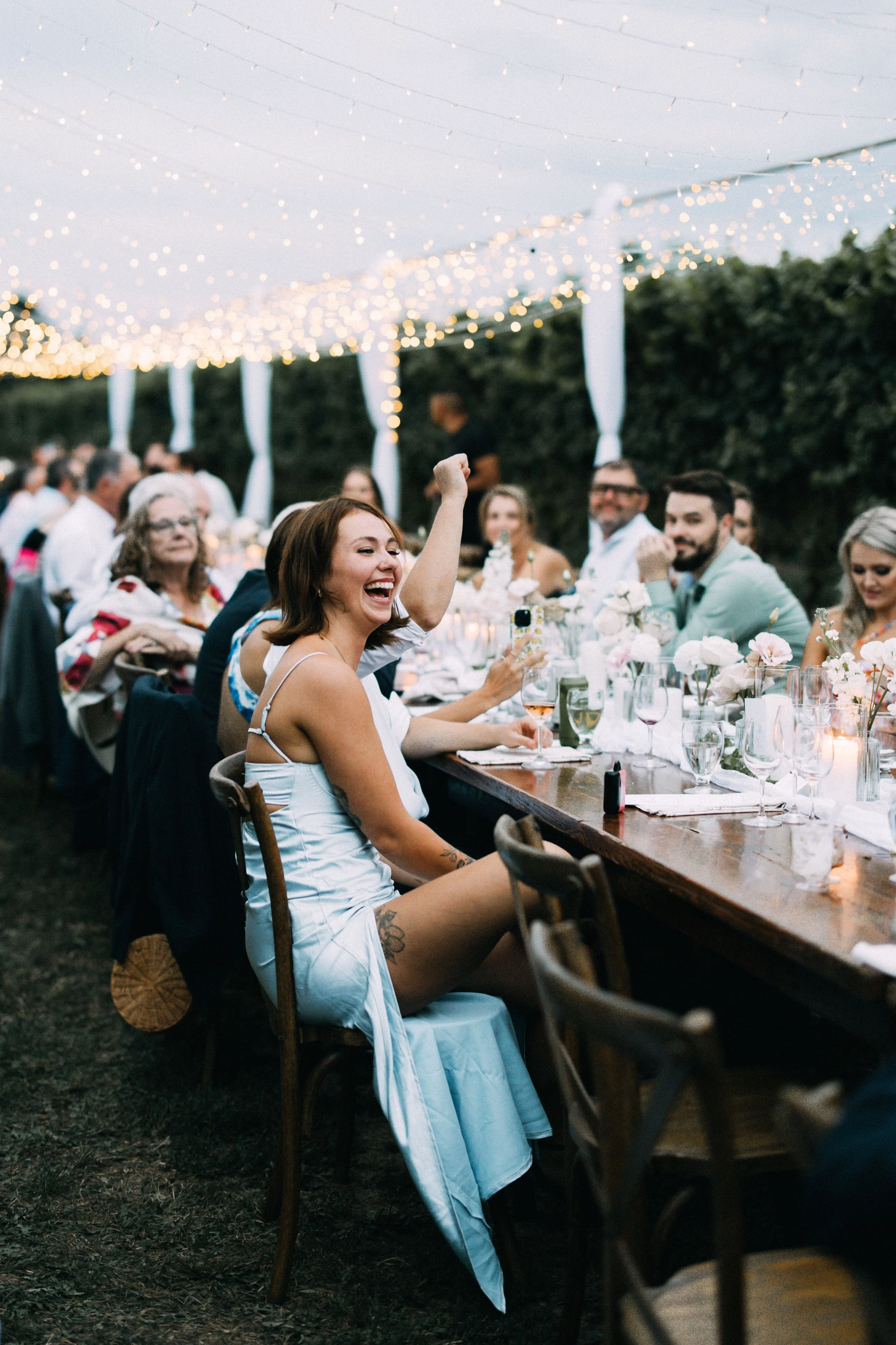 Twinkle lights over a long harvest table amidst the vineyards at Konzelmann Estate Winery.  Photo by Young Glass Photography
