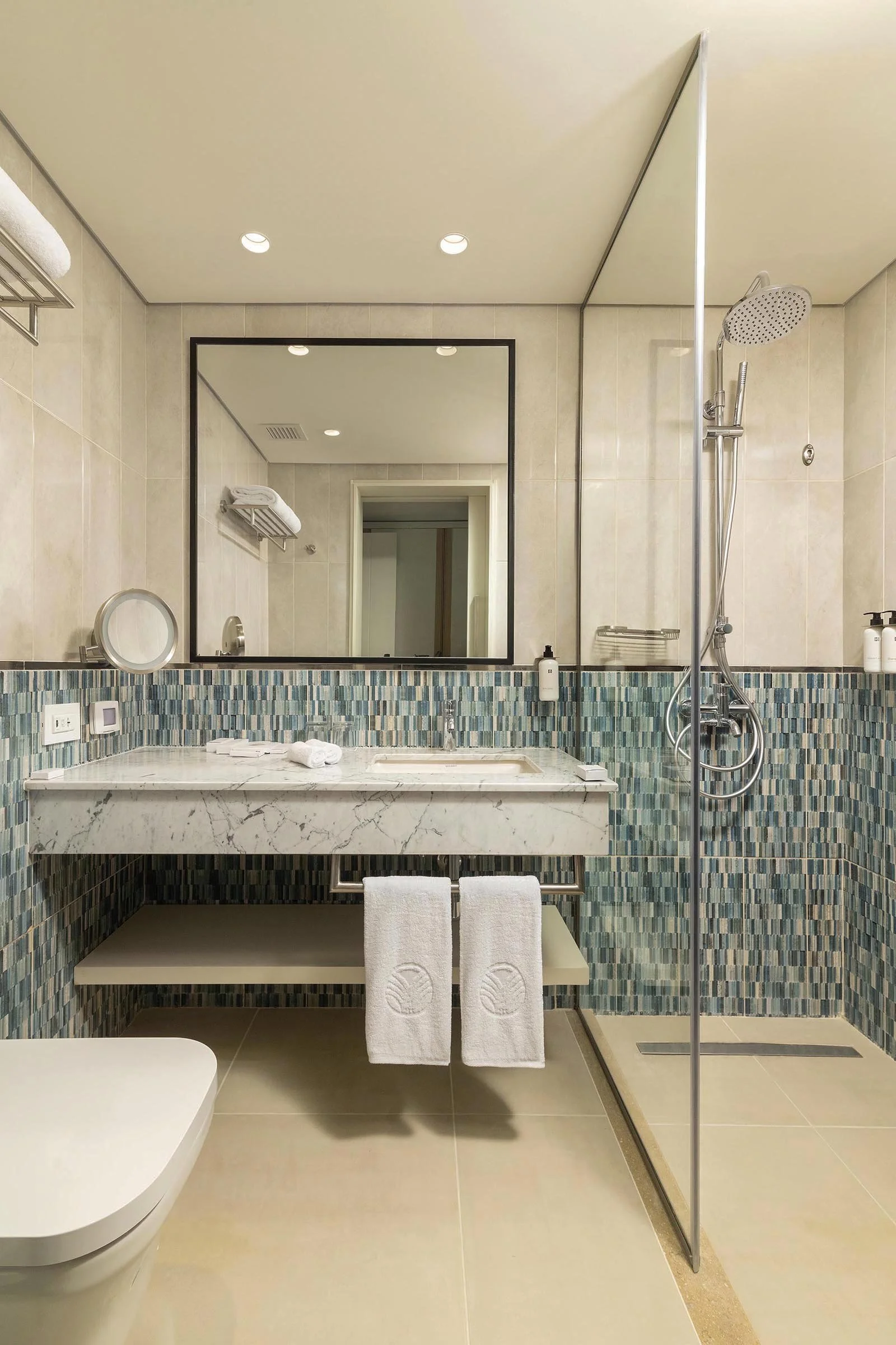 Modern bathroom with walk-in shower at Palma Bay Rotana Resort.jpg