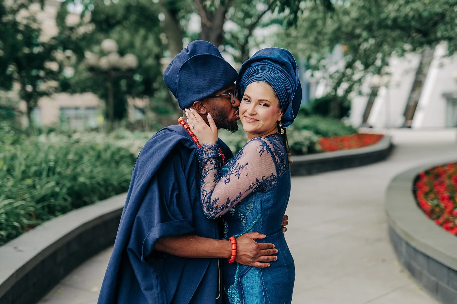 Couple in traditional blue wedding attire sharing a romantic moment outdoors at Arbor Midtown in Rochester, NY.