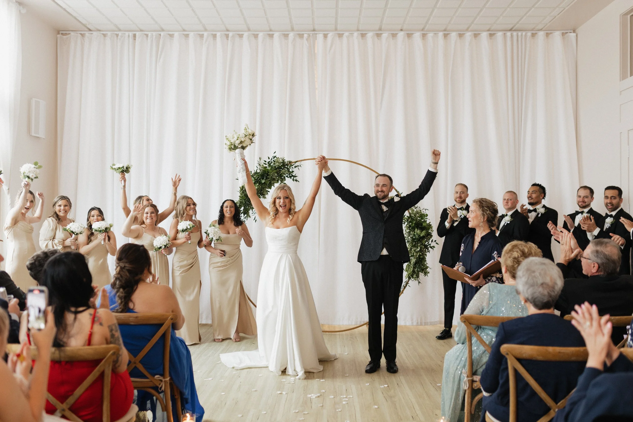Arbor at the Port wedding ceremony just married moment with bride and groom celebrating at the altar in a bright modern venue in Rochester, NY.