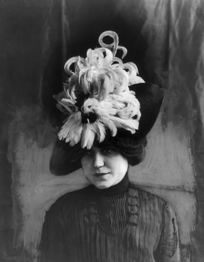 Woman wearing a hat made of bird feathers, circa 1912. Library of Congress