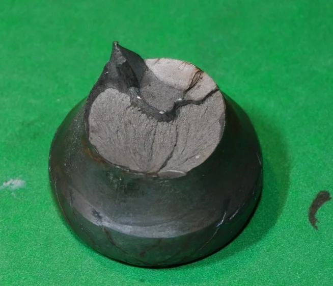 This is a failed cold head on a piece of rod rigging. The failure initiated at the flat sections at 1:00 and 6:00. This is a case of low stress/high cycle fatigue. The rig was not properly set up and was not disassembled or inspected on a regular basis. 