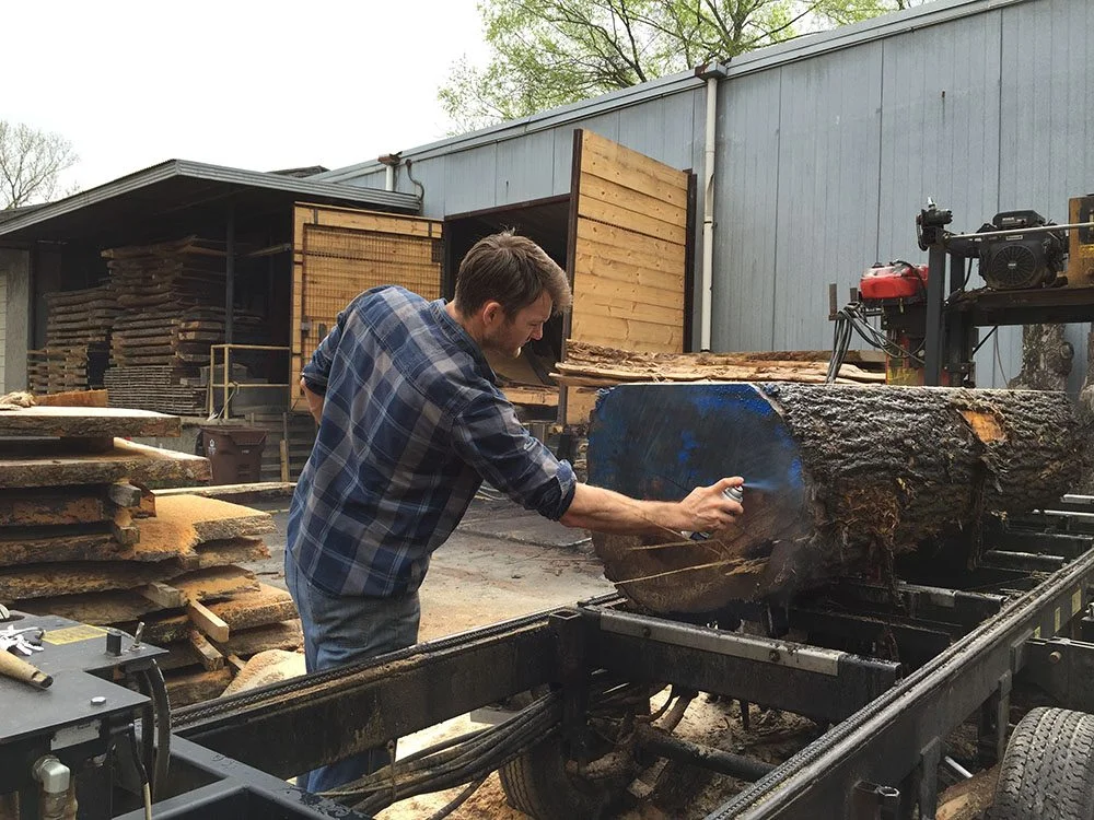 Once the logs from the trees arrive at Eutree's mill, they are tagged with blue paint to keep track of which ones came from the Westside Trail.