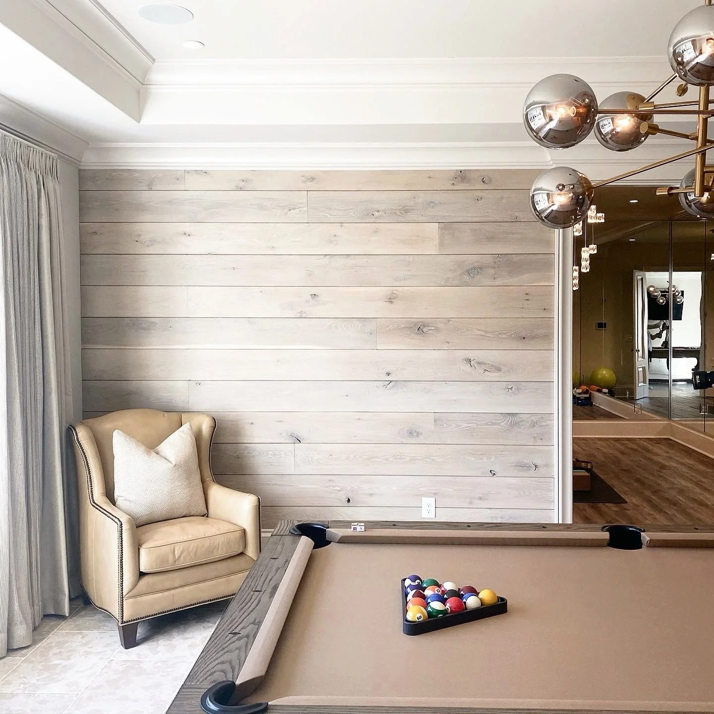Walls deserve the same attention as floors.

Our character white oak paneling in Canopy Sky introduces a light, atmospheric tone that softens the wood while preserving the natural grain and organic variation that make white oak so compelling. The res