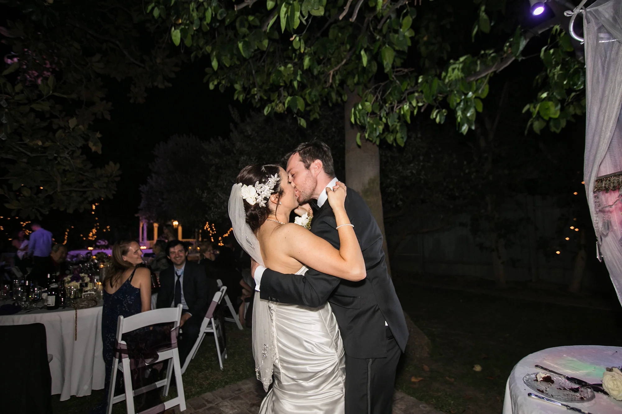 christmas house inn and gardens wedding carrie vines photography bride and groom kiss after cutting the cake