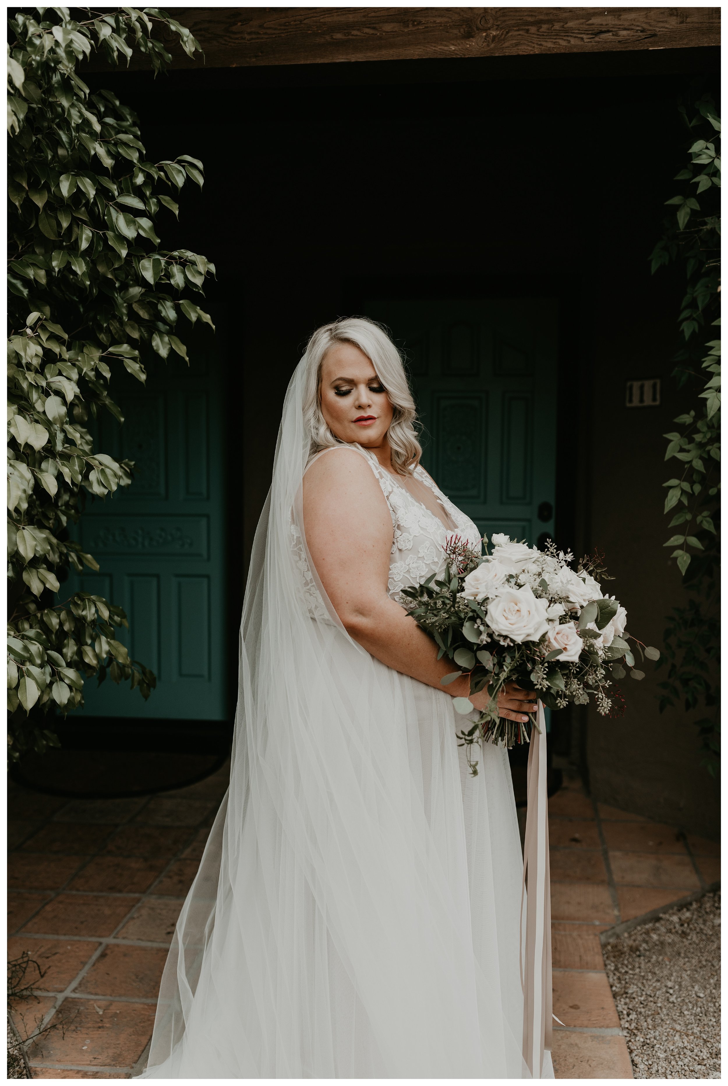Moody bridal portrait at Hermosa Inn with large romantic bouquet and long veil