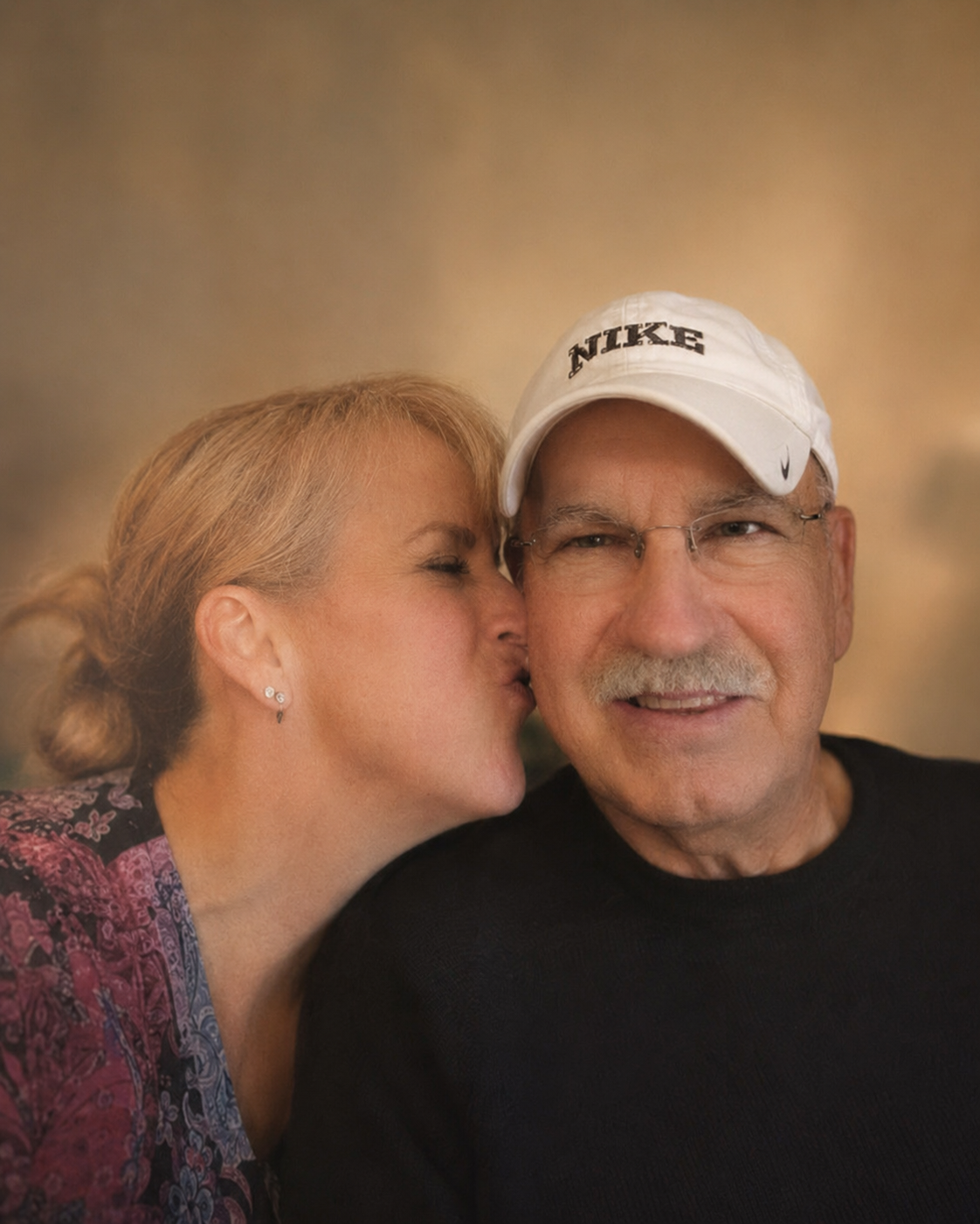 KatMoon Landes kisses her father on the cheek in a warm family portrait.
