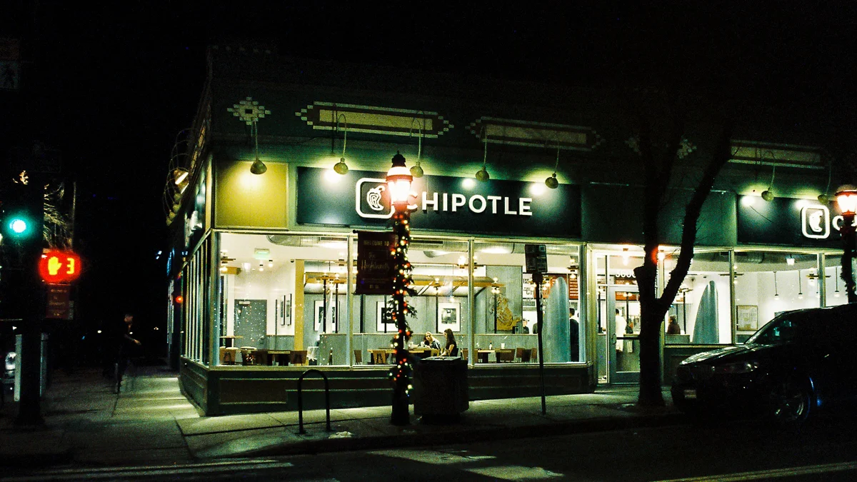 The lighted street corner at Chipotle in the Highlands