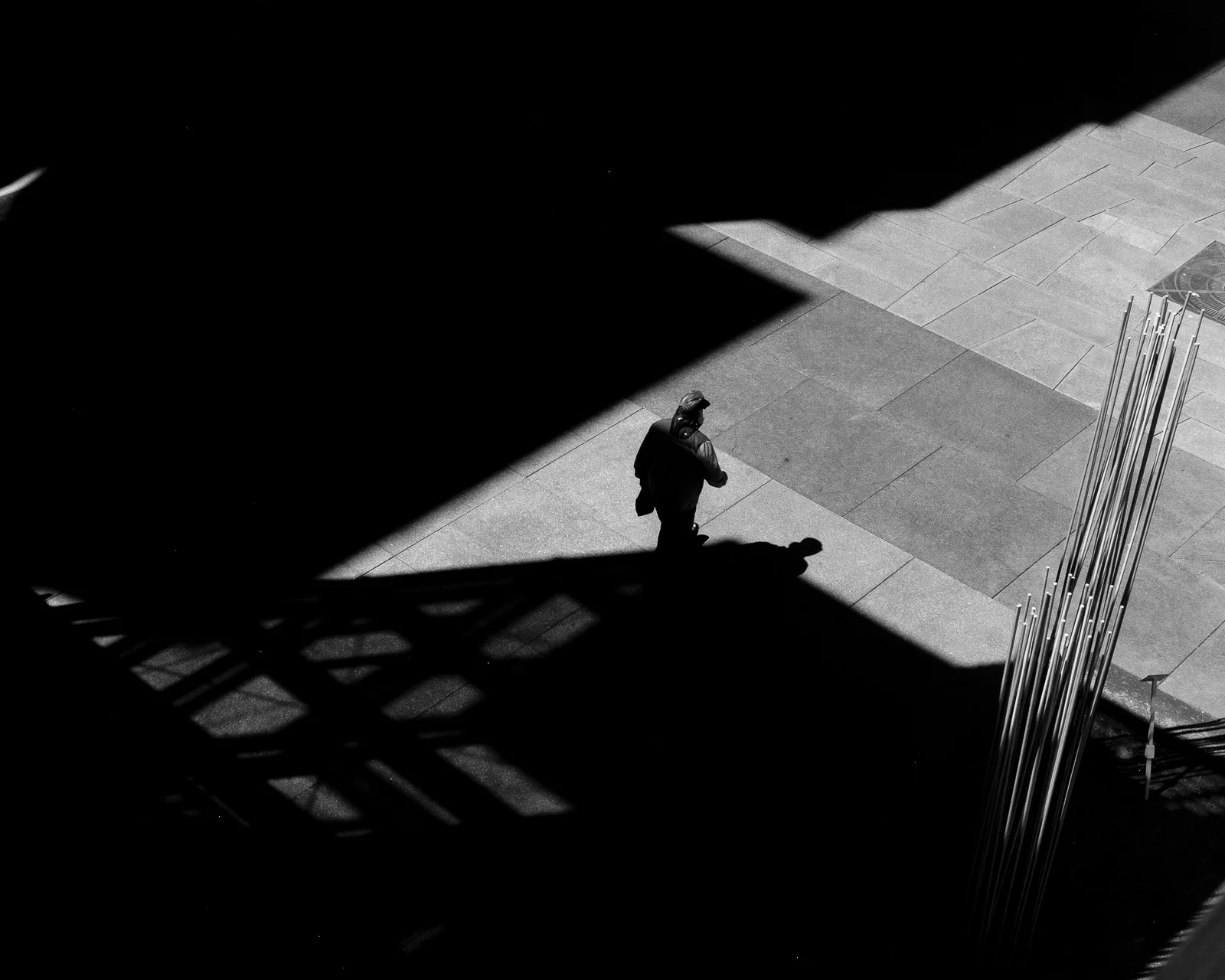 Day 133- 365 Day B&W Photo Challenge - A man walks out of the shadows below the Millenium Bridge in Denver, Colorado - Fuji X100F, Acros R Film Simulation