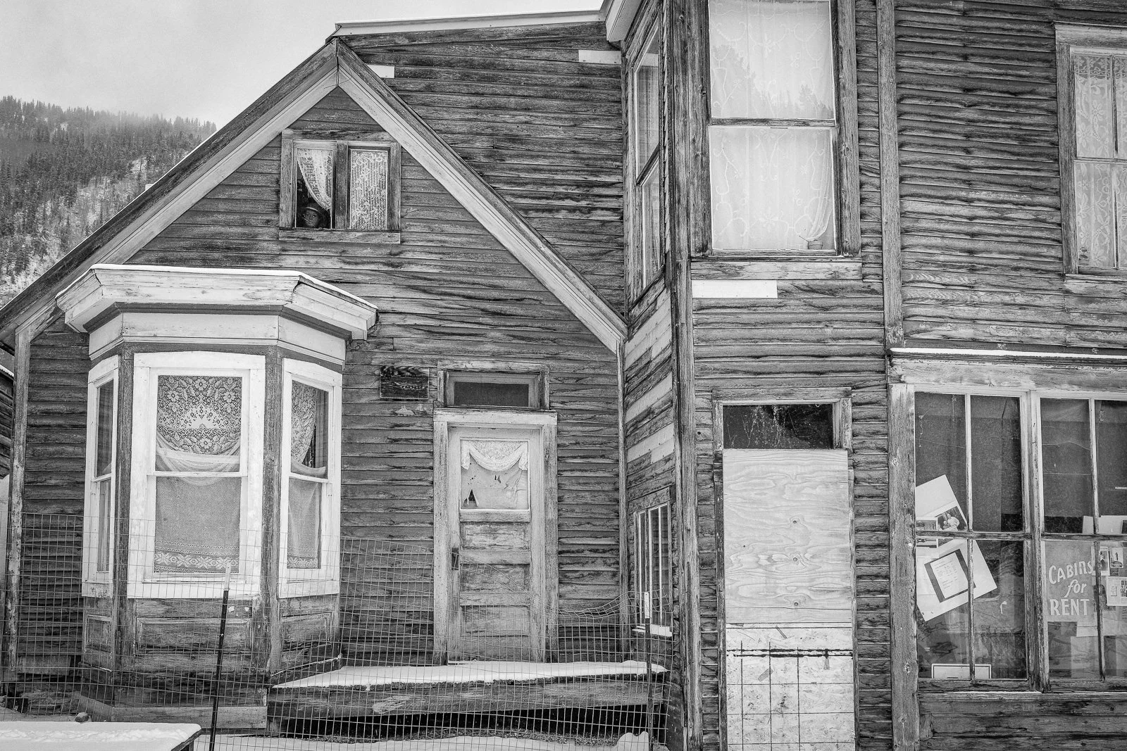 Day 142- 365 Day B&W Photo Challenge - Do you see someone looking at you? It freaked me out when I first saw it. A face pearing out of this abandoned building in St. Elmo ghost town near Buena Vista, Colorado.. - Fuji X-T3, XF 35mm f/2, Acros R Film Simulation