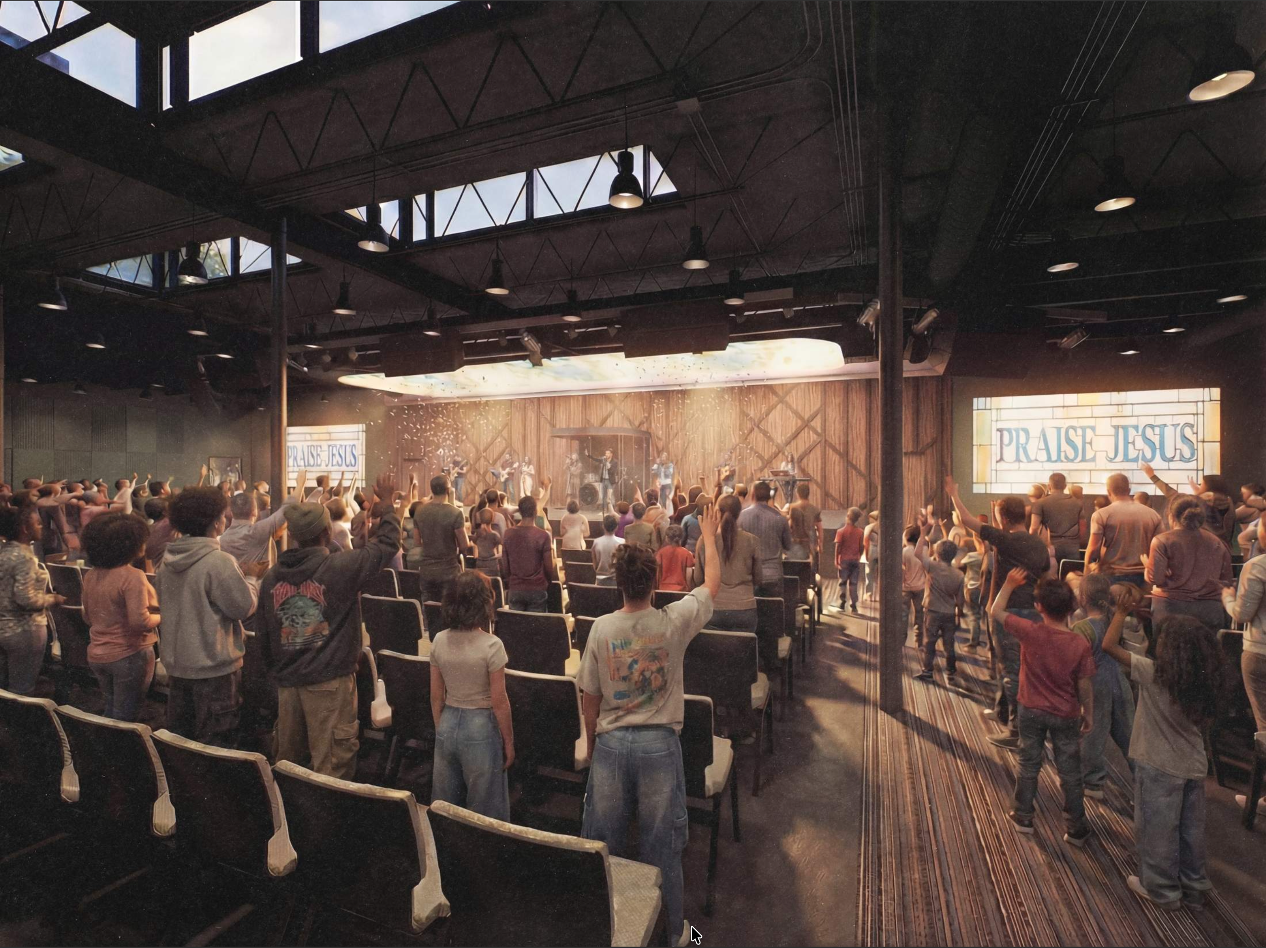 A large group of people gathered in an indoor church or auditorium during a service or event, with some standing with hands raised and others sitting, facing a stage with a large screen displaying the words "PRAISE JESUS." The stage has a band and speakers, and the ceiling features skylights and hanging lights.