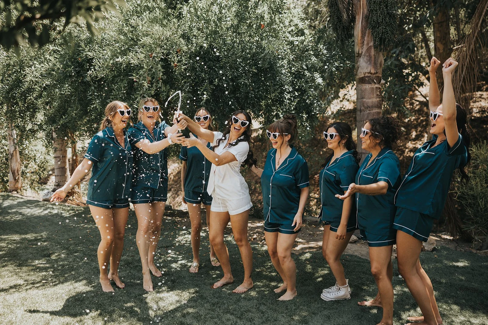 bridesmaids at los willows cheering with an fizzy bottle of champange