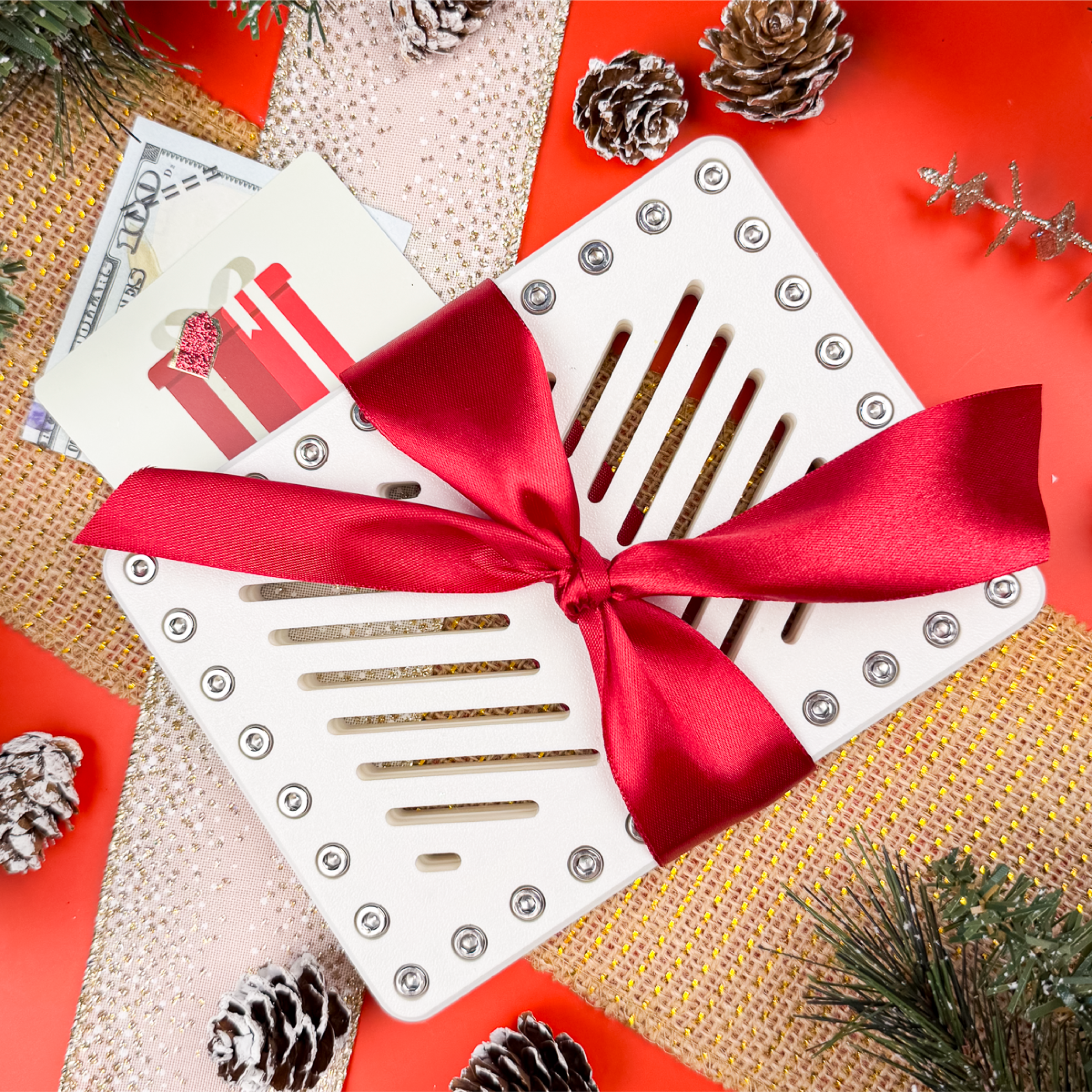 Pure Snow Lockup Duo with red ribbon. Holiday puzzle money holder for two gift cards or cash with 40 screws. Funny Christmas prank gift, Secret Santa idea, or unique stocking stuffer.