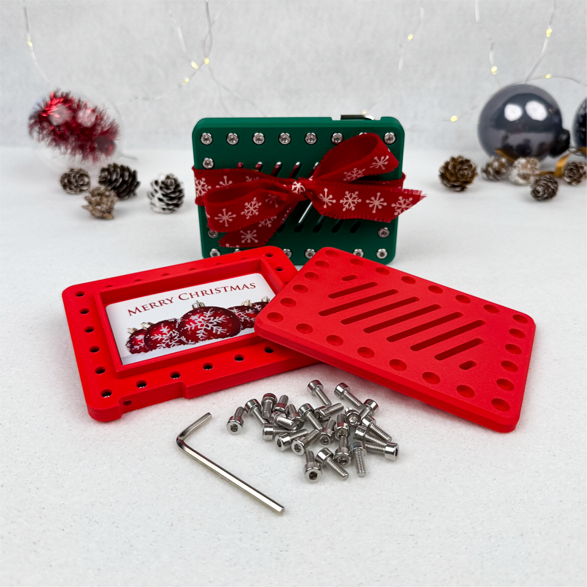 Molten Rose Lockup Gift Card Holder with Merry Christmas card, Imperial Emerald behind. Festive box for cash or gift cards, making holiday gifting a funny Christmas prank or Secret Santa idea.