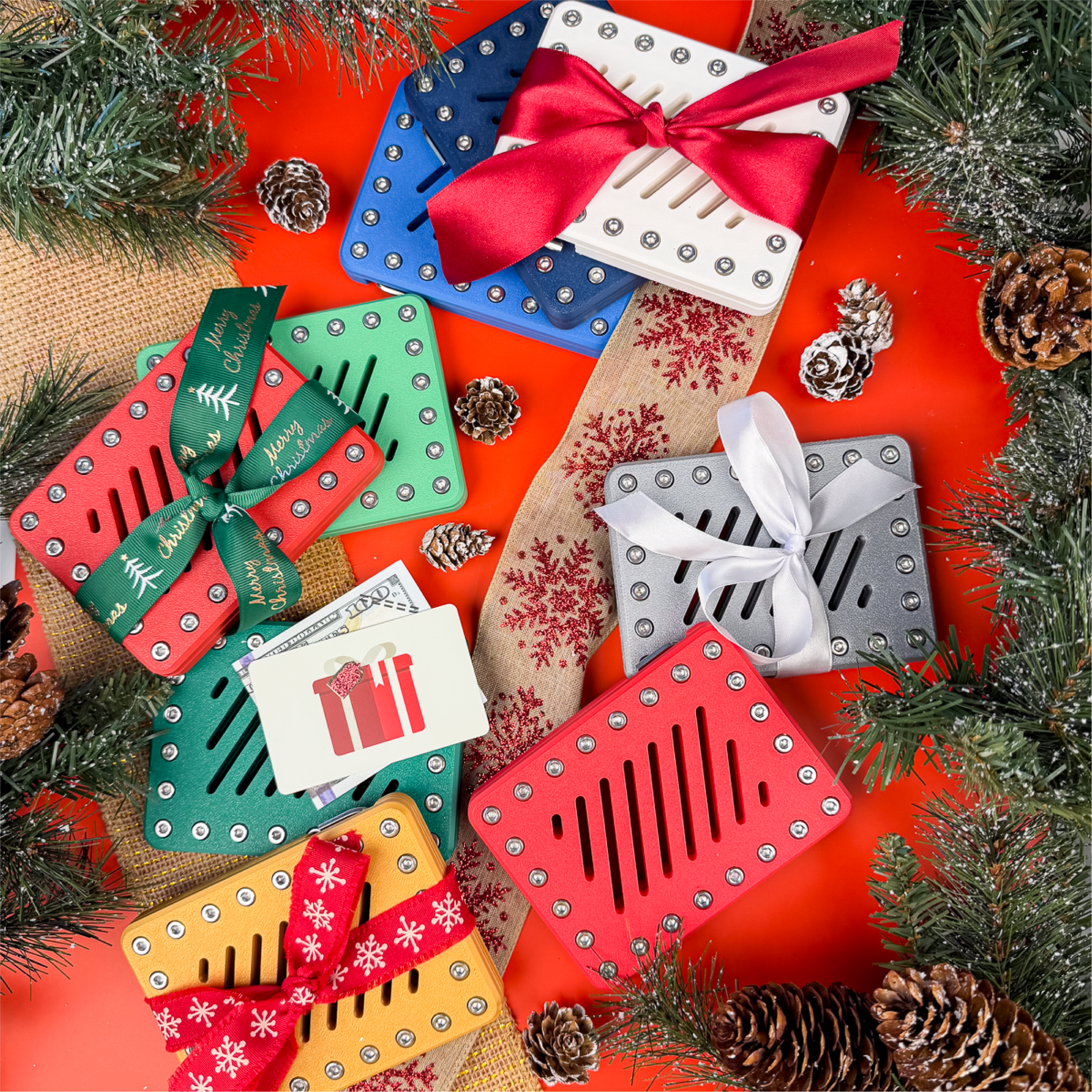 Holiday Lockup Gift Card Holders in Pure Snow, Molten Rose, Imperial Emerald, Golden Mirage, and Polished Mercury with festive bows. Puzzle money holders for cash or gift cards.