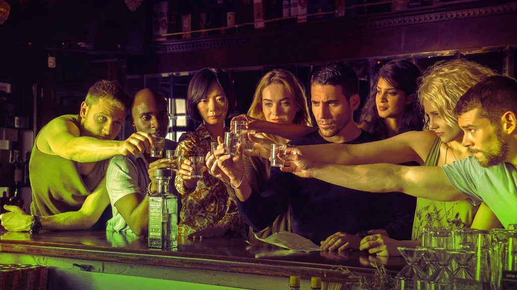 The empathically-linked cluster in Sense8 shares a drink.