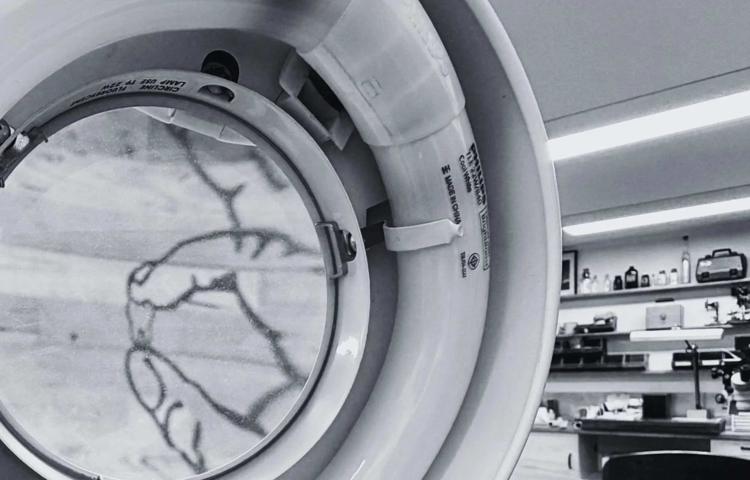 black and white interior of prosthetics dental studio through magnifying glass at Adelaide Laboraties