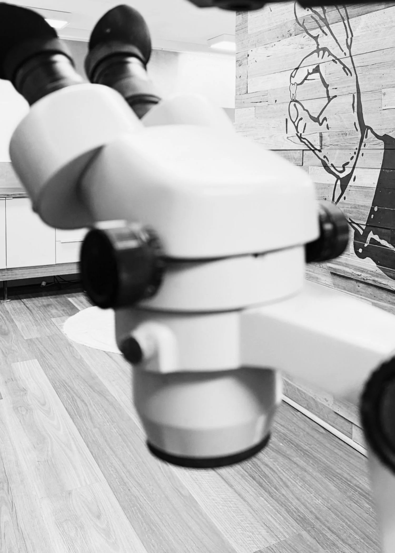 black and white photo of microscope in dental prosthetic lab at Adelaide Laboratories