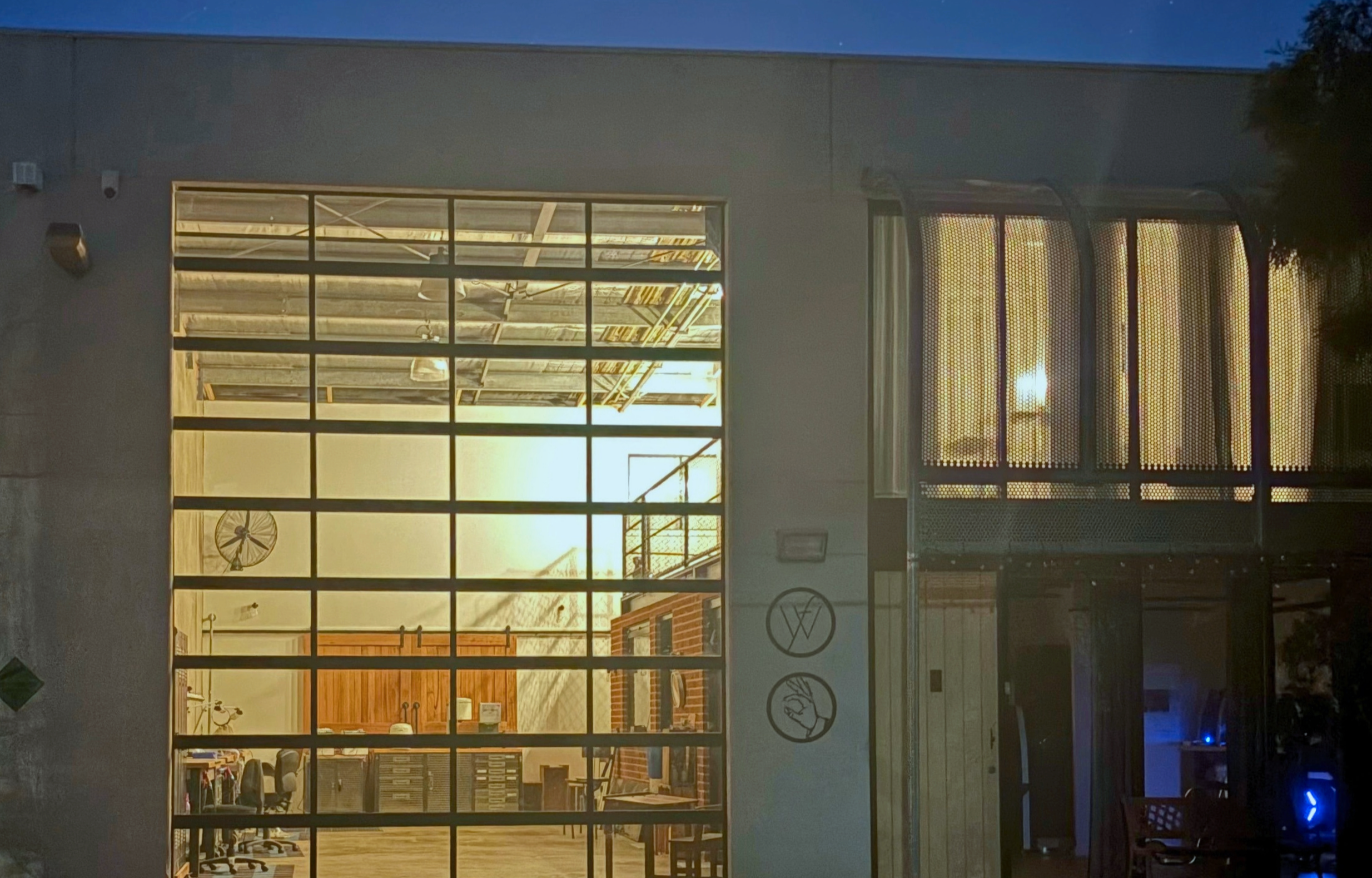 Adelaide Laboratories dental laboratory at night, with illuminated workbenches and dental technology visible through large front windows in Adelaide,  South Australia.