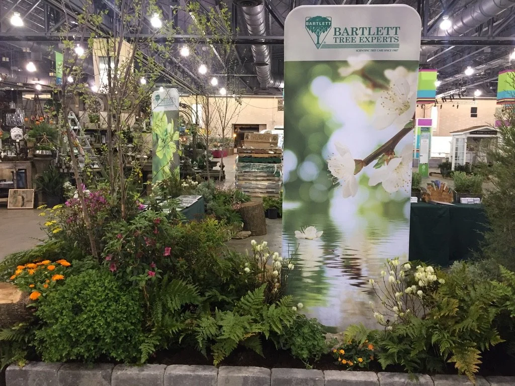 Booth layout and floral styling for Bartlett Tree Services at PHS Flower Show 