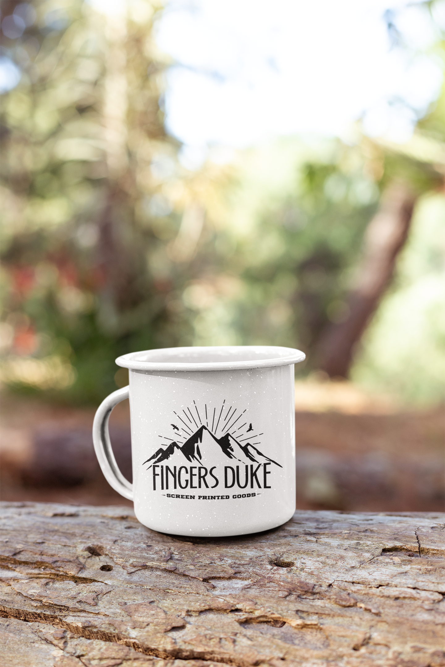 mockup-of-a-small-enamel-mug-in-the-woods-26919.png