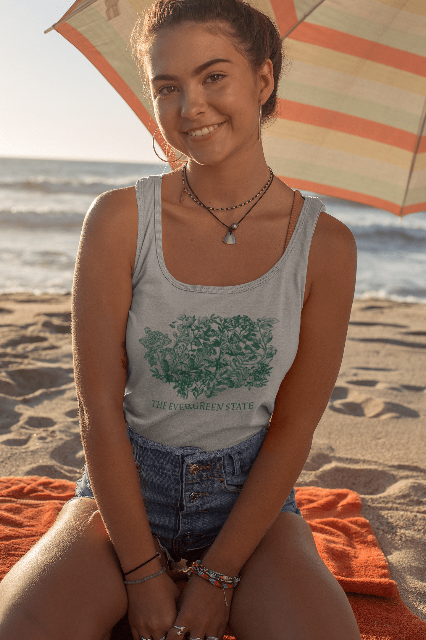 tank-top-mockup-of-a-smiling-woman-sitting-under-a-beach-parasol-26780.png