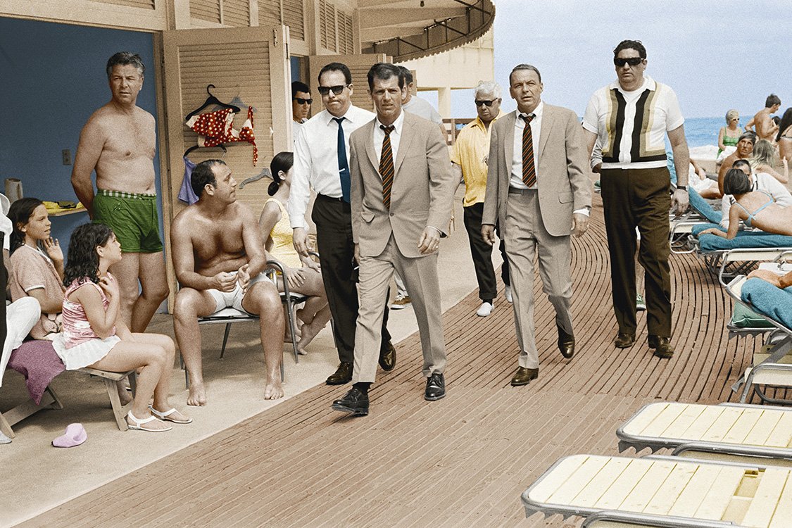  Singer and actor Frank Sinatra, with his minders and his stand in (who is wearing an identical outfit to him), arriving at Miami beach while filming, 'The Lady in Cement', 1968.  