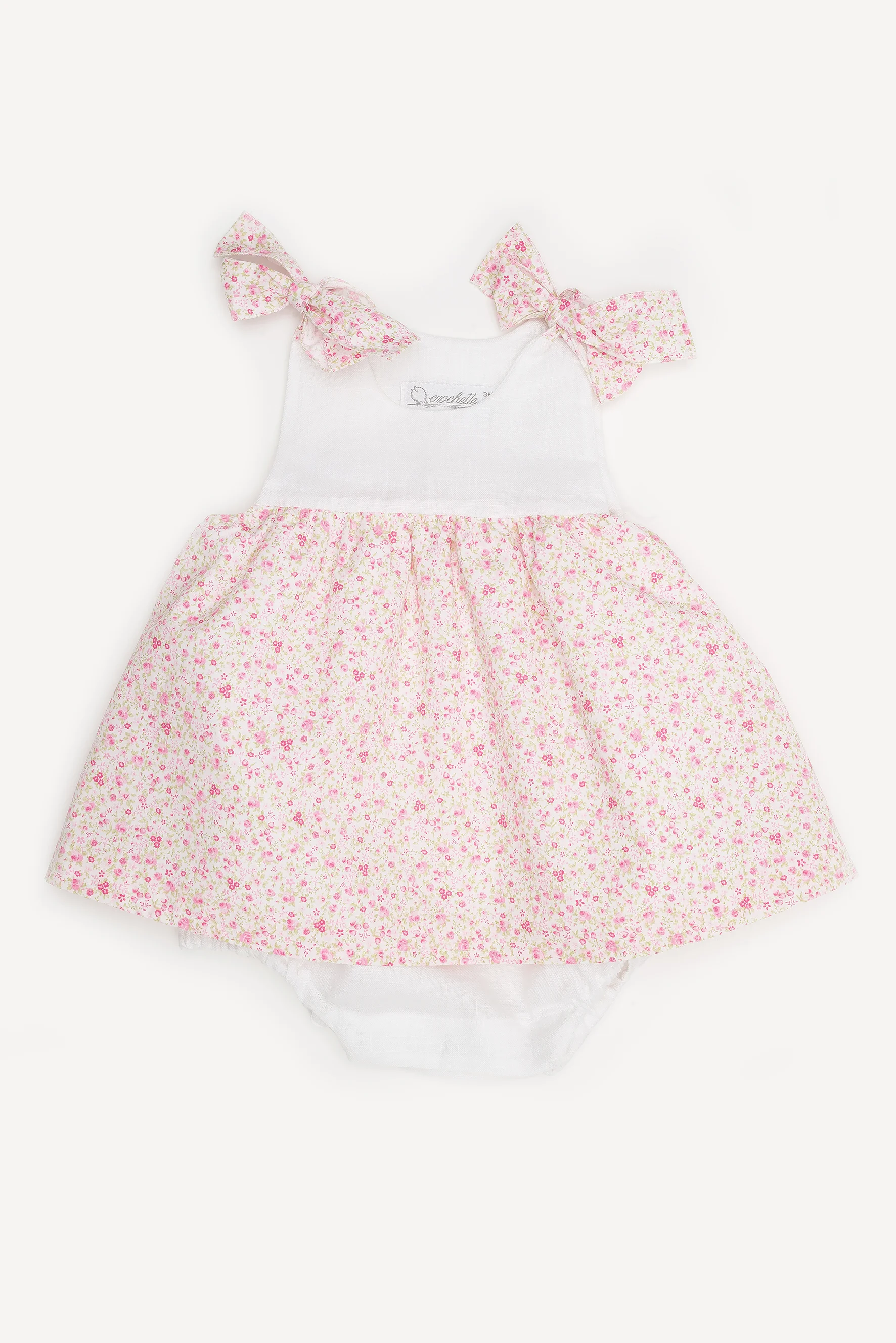 Pagliaccetto neonata con fiocchi a fiori rosa