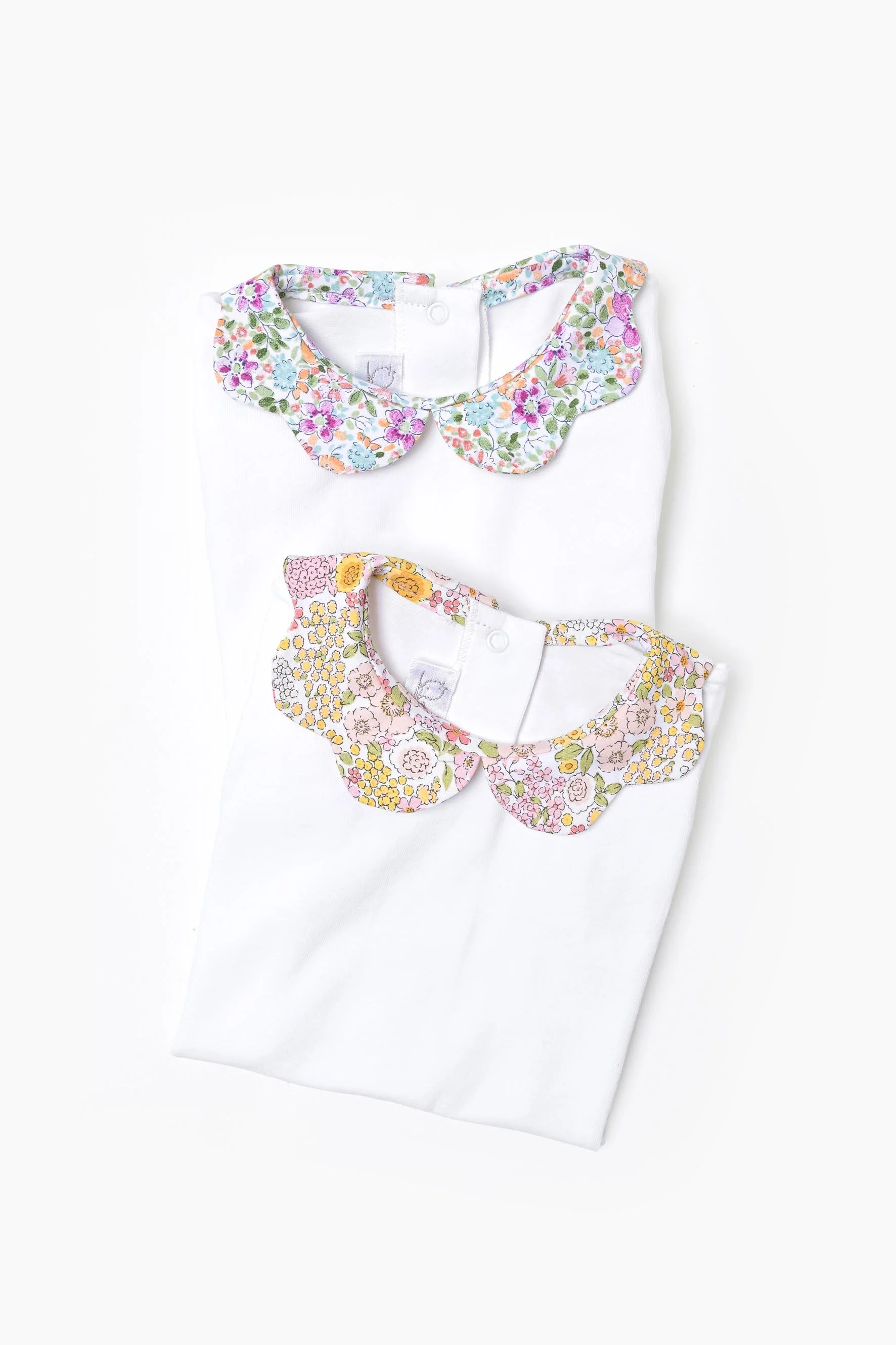 Body neonata jersey bianco e fiori rosa e viola