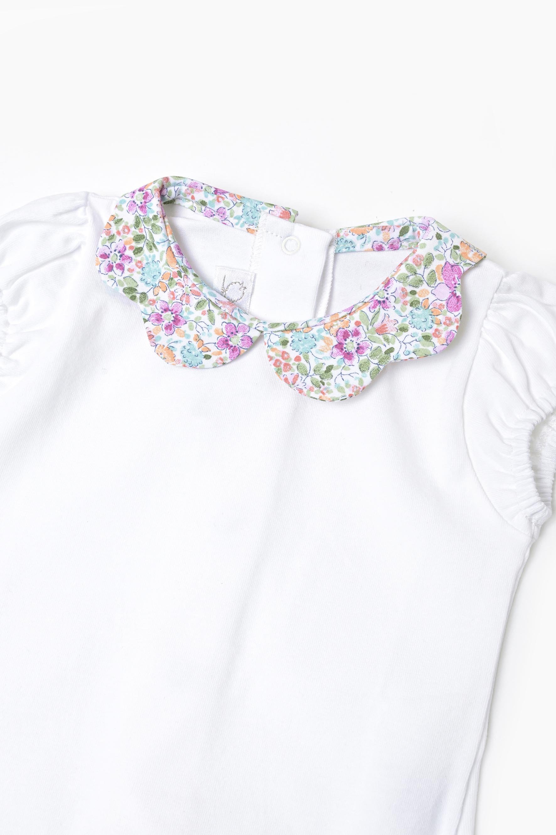 Body neonata jersey bianco e fiore viola turchese